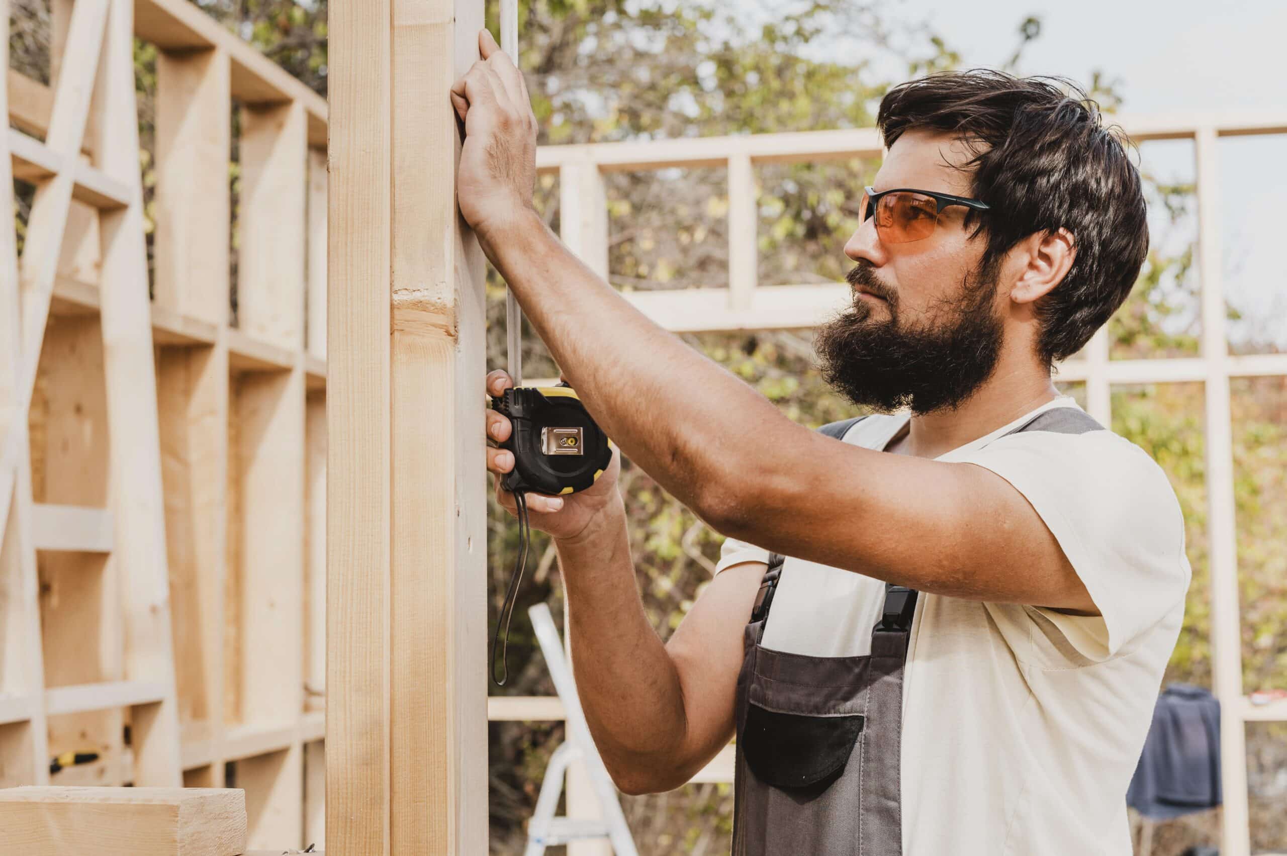 carpenter-man-using-tape-measure house siding installer scaled